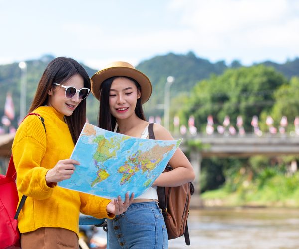 Tourist, Two female tourists hold a map to find places.